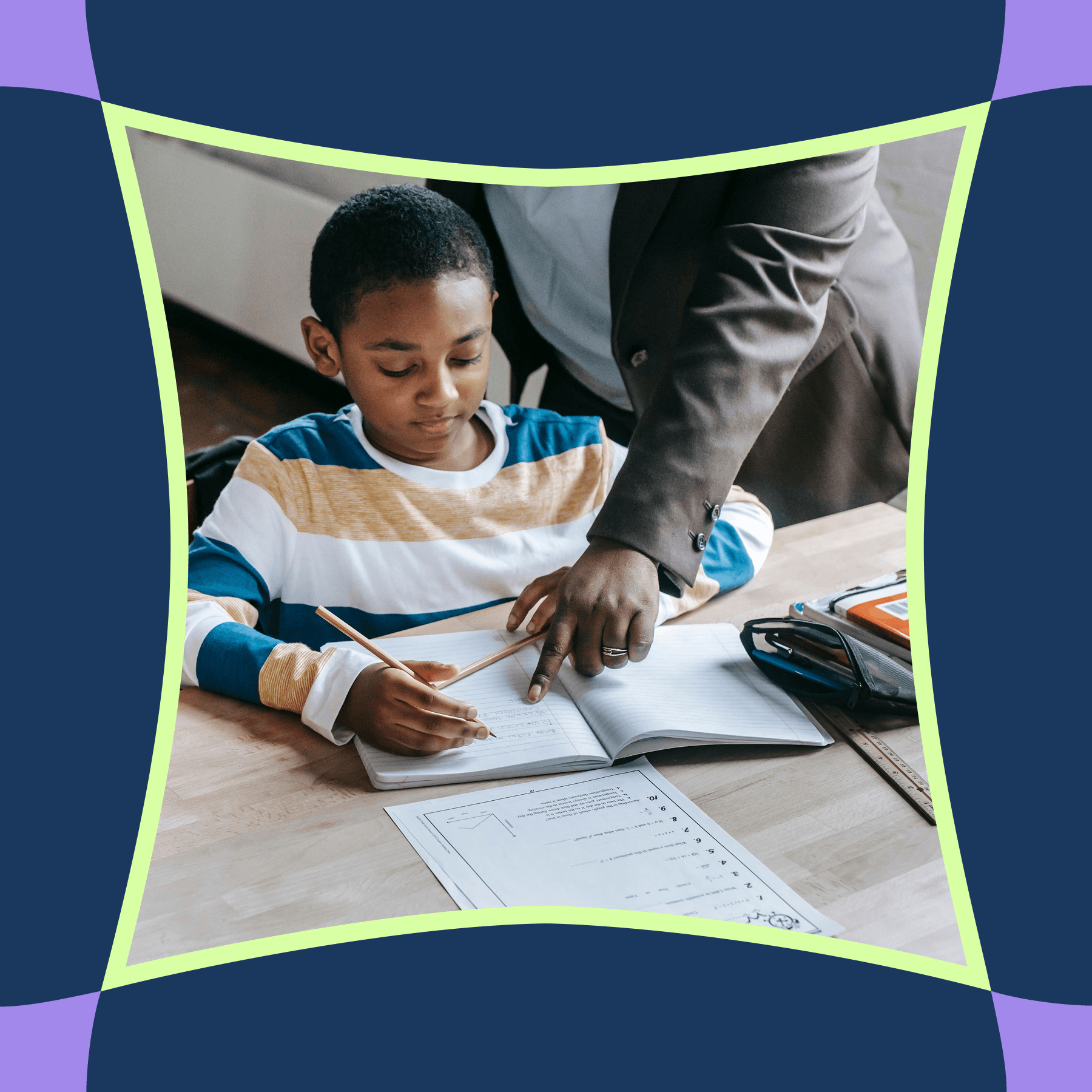 A boy writing at his desk while a teacher points out a correction in his notebook