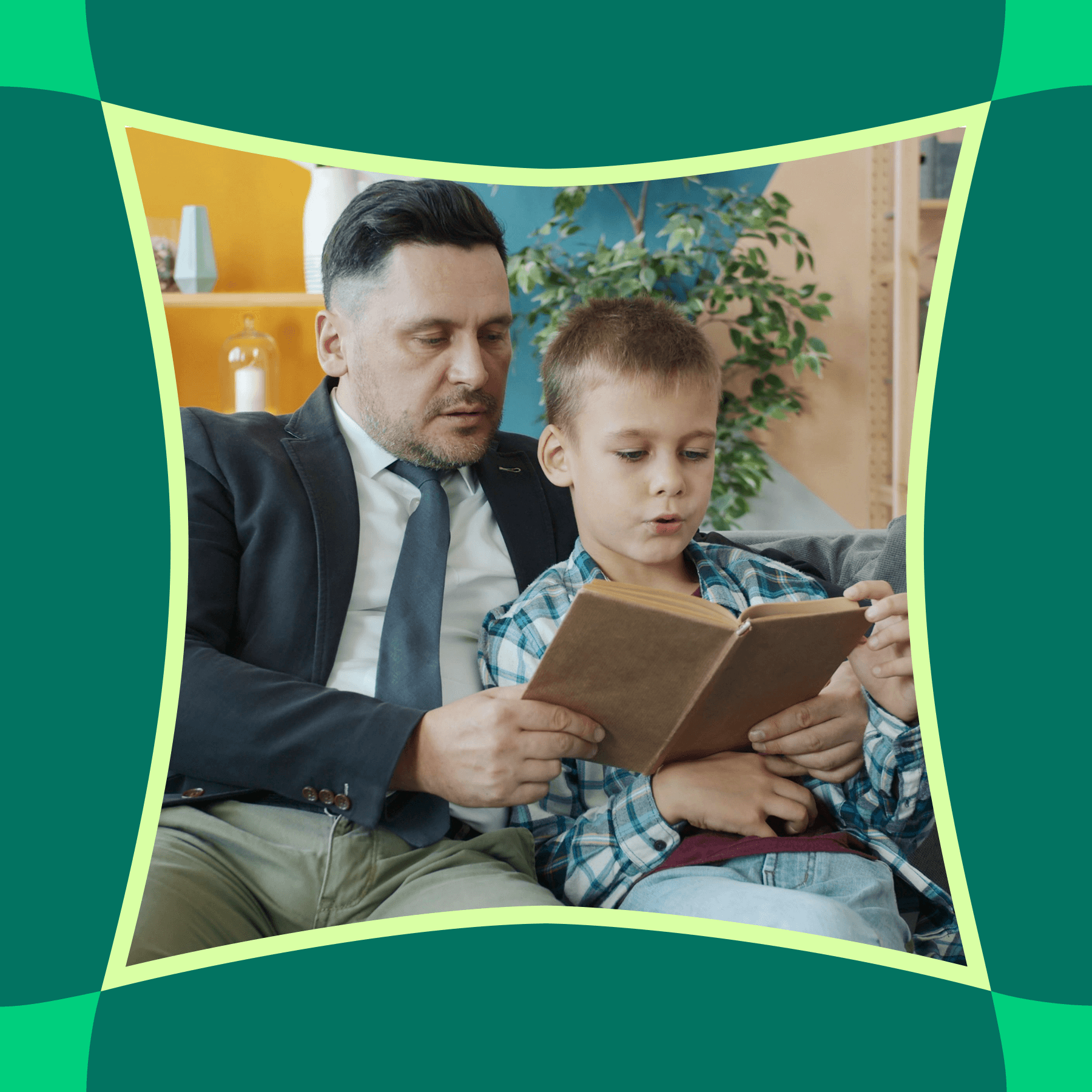 A father and son reading a book together on a couch at home